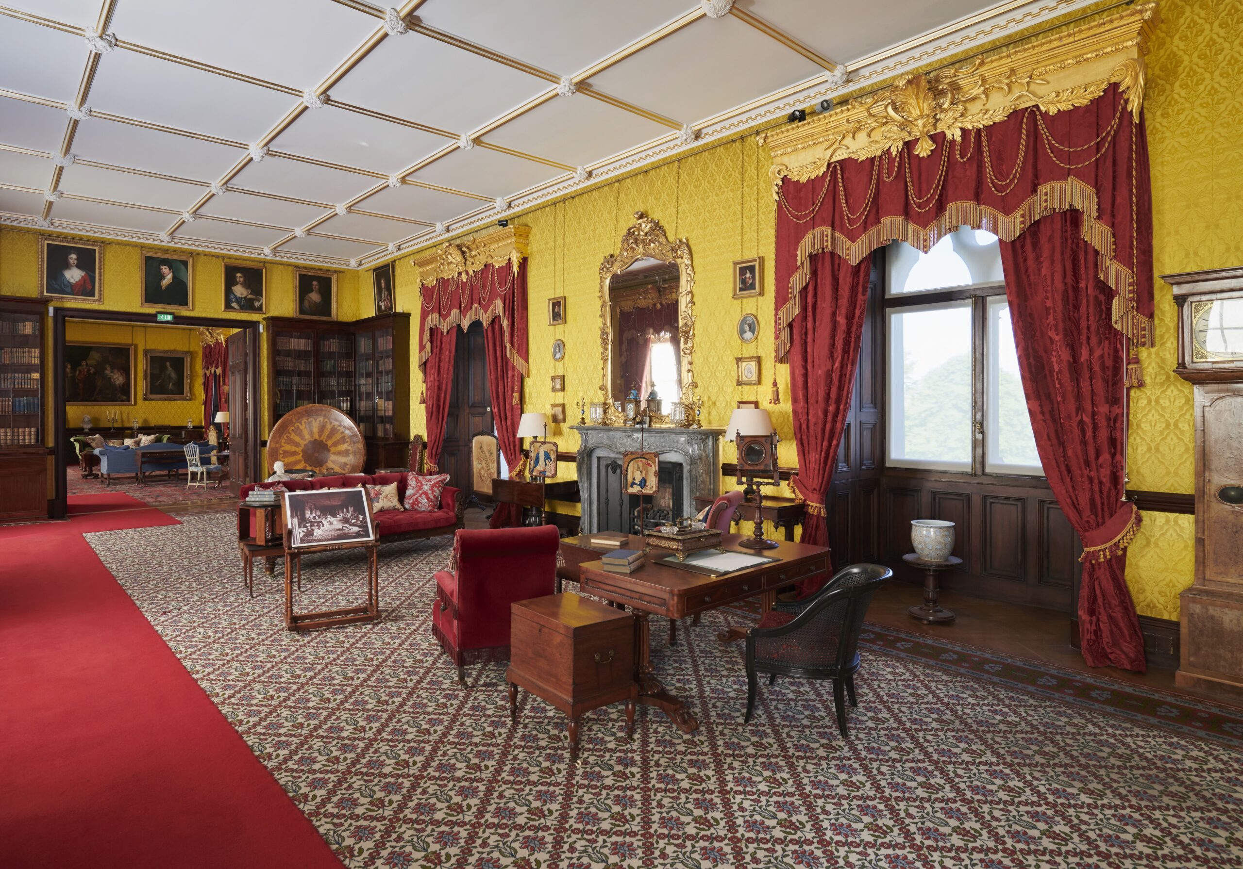 View of Kilkenny castle's Library and Drawing Room from the Anteroom with Victorian and Edwardian furniture and paintings from the Ormonde Collection on the walls.